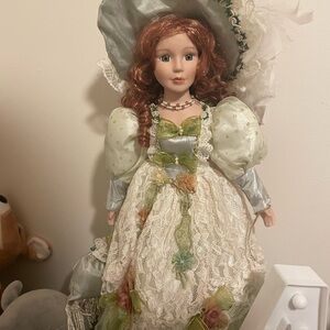 Elegant Porcelain Doll with Green and Cream Dress